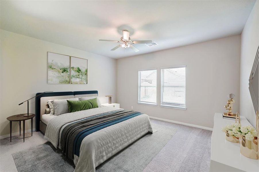 This is a well-lit, cozy bedroom featuring neutral walls, carpet flooring, a ceiling fan, and two windows providing ample natural light.This spacious bedroom  it’s well-lit by a flush mount ceiling light, creating a bright and versatile space.