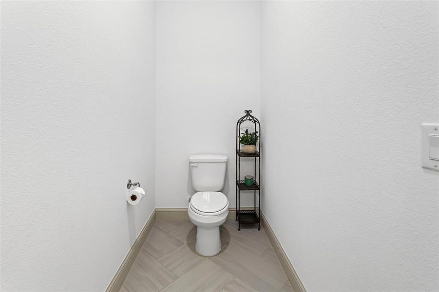 Bathroom featuring toilet and tile patterned floors