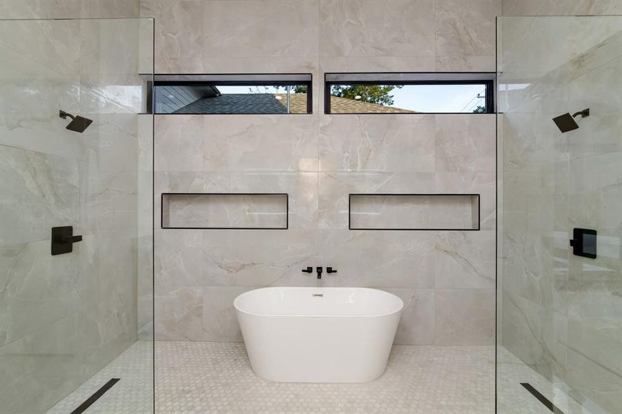 Bathroom featuring tile walls and a shower with door