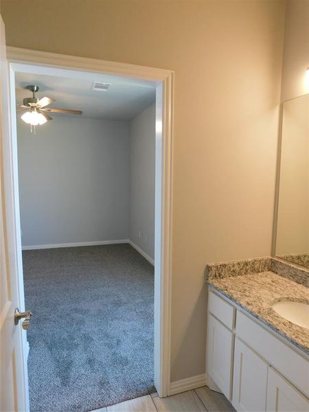 Bathroom with vanity and ceiling fan