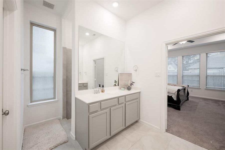 Experience the ultimate in bathroom luxury with this stunning primary bathroom, featuring a spacious standing shower with rainfall showerhead and separate showerhead.