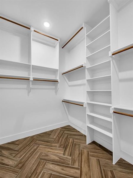 Spacious closet with parquet flooring