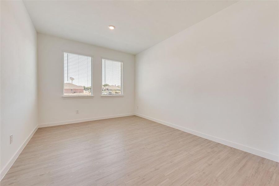 Unfurnished room featuring light wood-type flooring