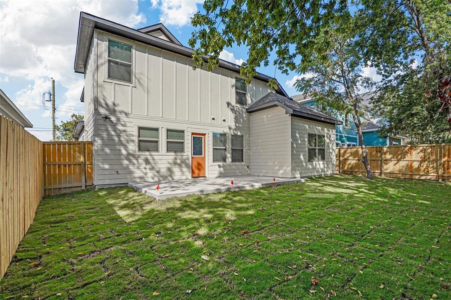 Back of property with a patio and a lawn