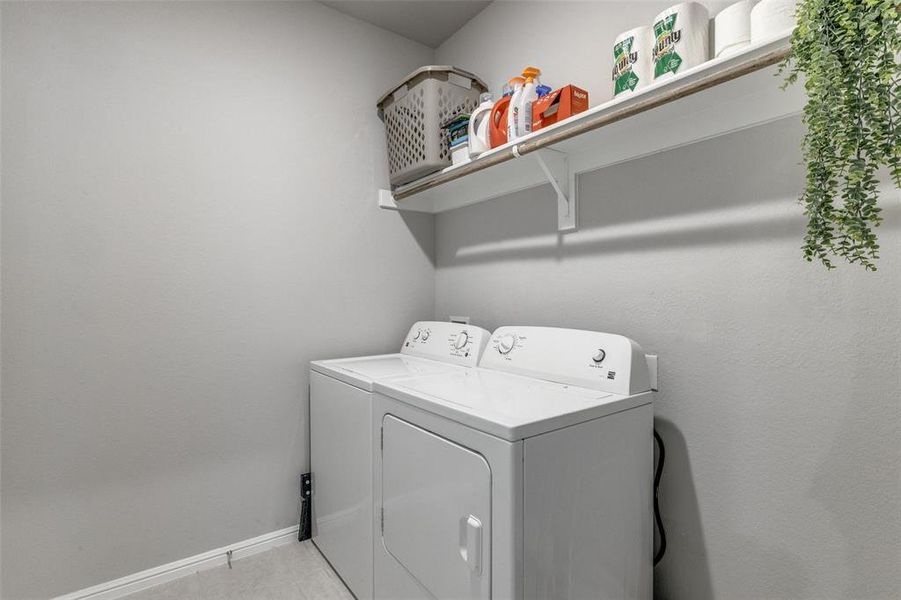 Washroom with washer and clothes dryer