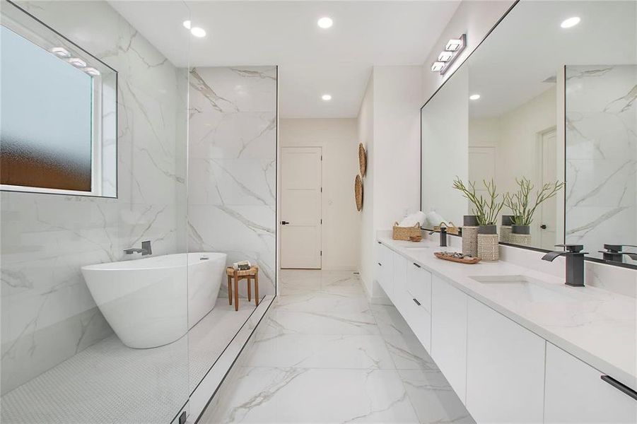 Bathroom with tile walls, vanity, and a bathtub