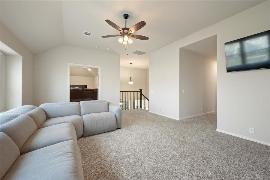 The game room or 2nd living area has carpeted flooring and is very spacious.