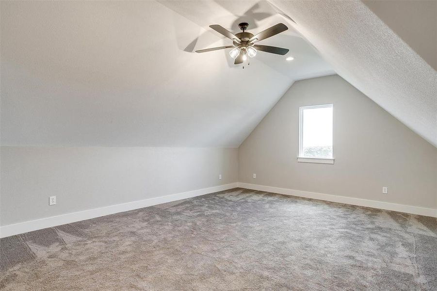 Bonus room with vaulted ceiling, and ceiling fan