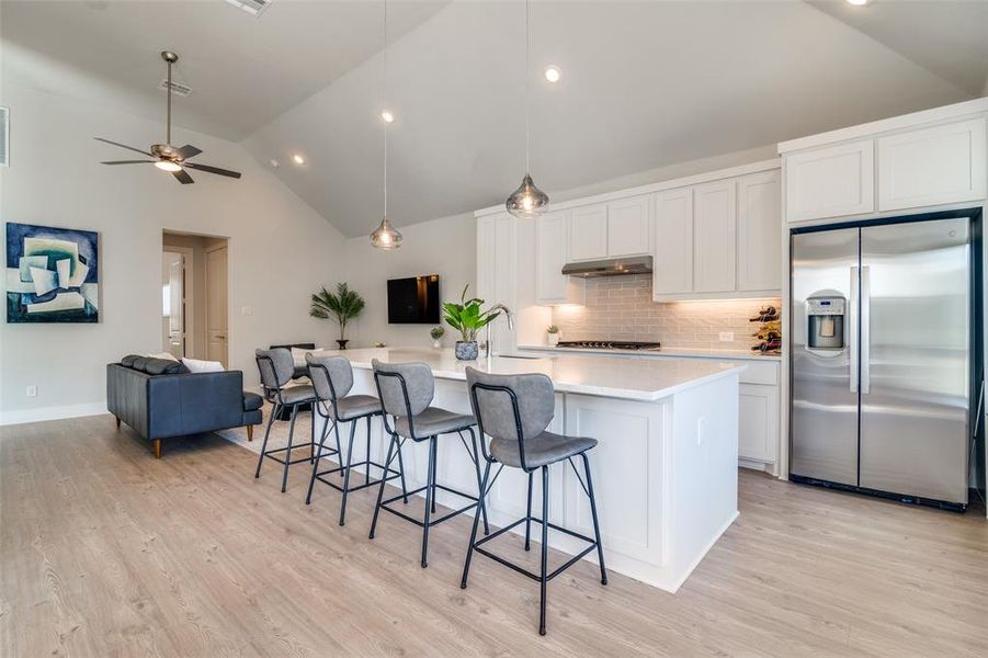 The large quartz kitchen island offers additional storage via four cabinets on this side of the island.