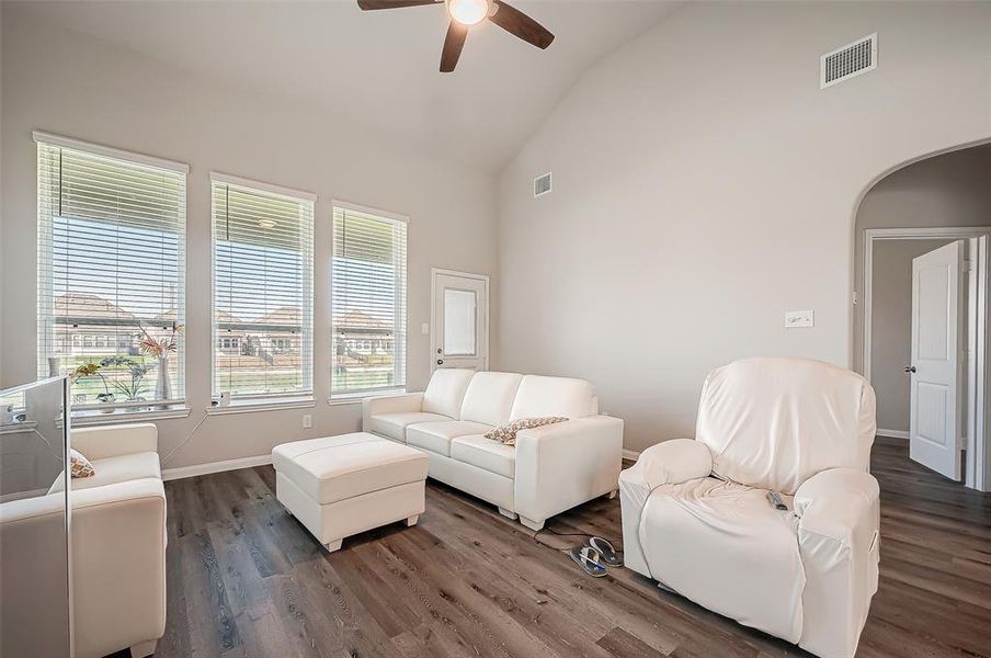 The living room is a true showstopper, highlighted by a dramatic wall of windows that flood the space with natural light and showcase breathtaking lake views.