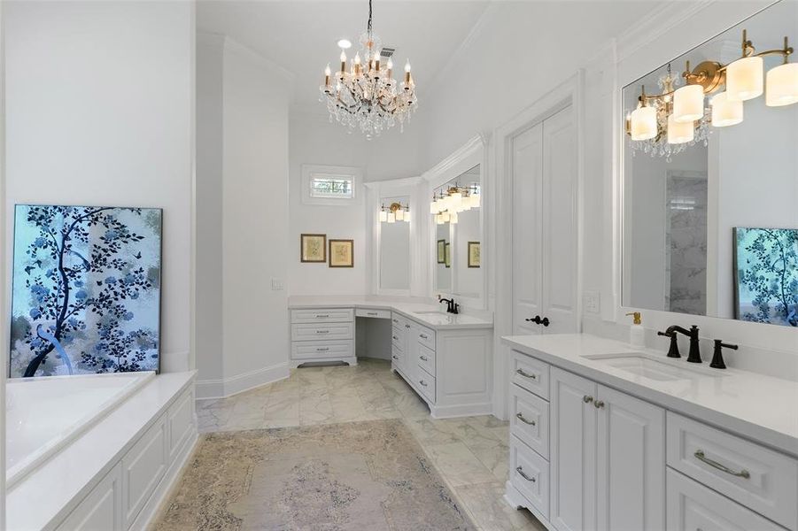 Step into the sanctuary of the primary bath. Fabulous is the only way to describe this luxurious bath with double sinks, quartz counters, precious chandelier light, and a vanity area.