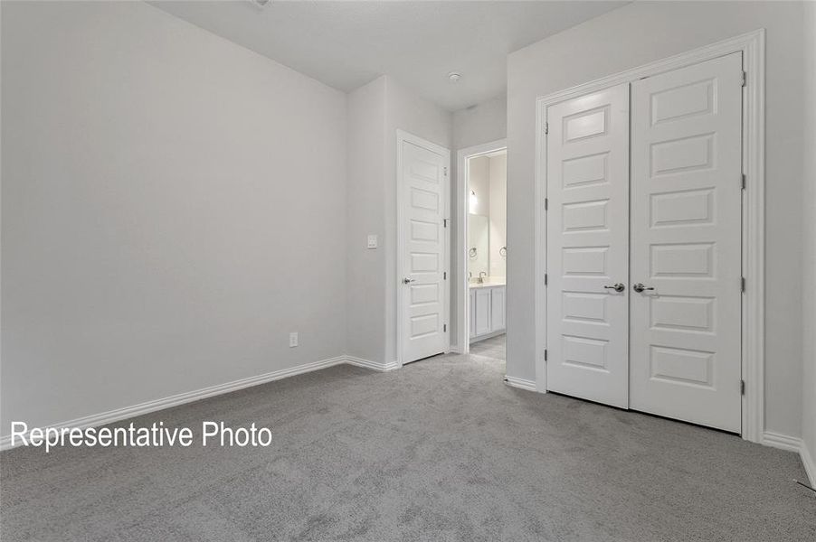 Unfurnished bedroom with a closet and carpet floors