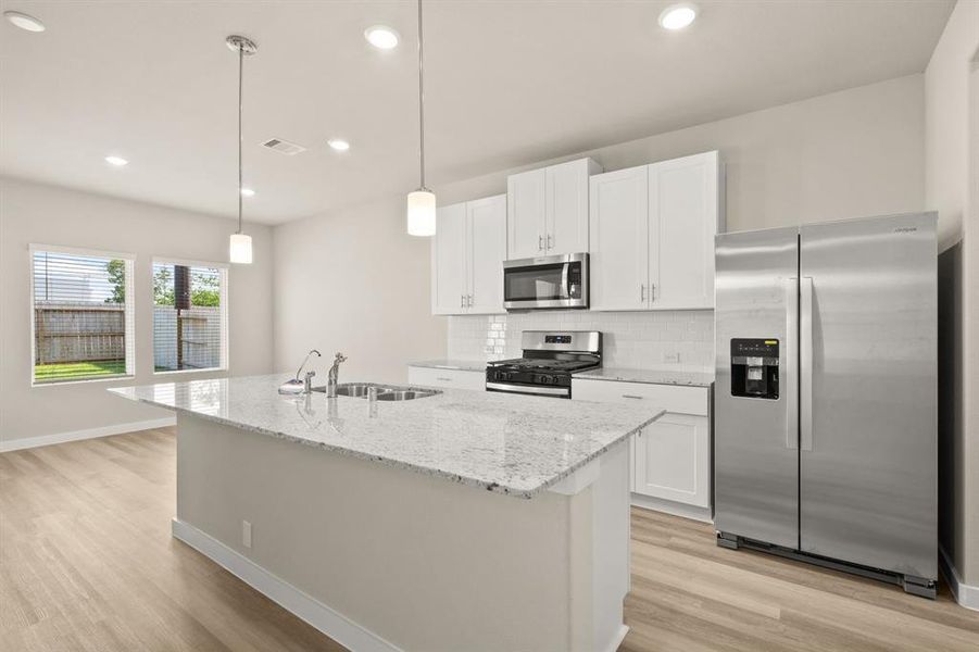 Welcome to the Gourmet Kitchen! The white cabinetry, oversized island, breakfast bar for additional seating and Stainless Steel appliances are just a few of the highlights.