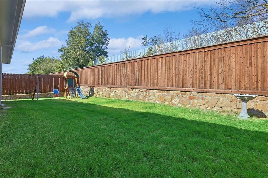 Large backyard with higher privacy fencing, no neighbors behind- just trees