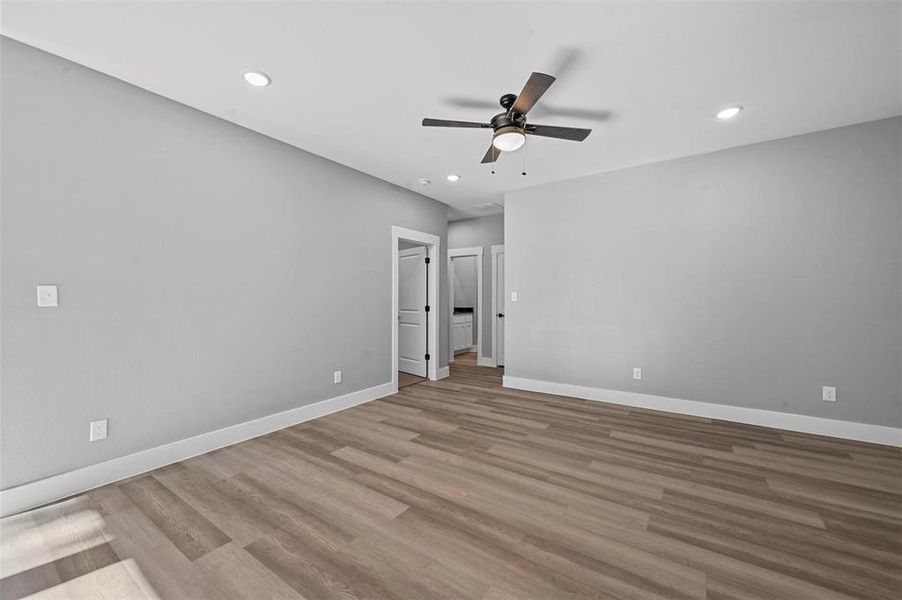 Spare room featuring ceiling fan and light hardwood / wood-style flooring