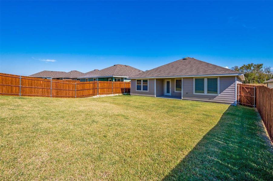 Back of house featuring a lawn