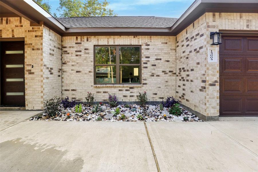 The exterior of the house features a combination of brick and stone on all sides.