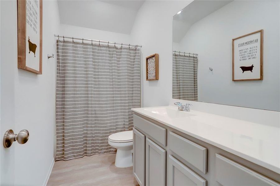 SECONDARY BATHROOM WITH LONG VANITY AND A TUB & SHOWER COMBO.