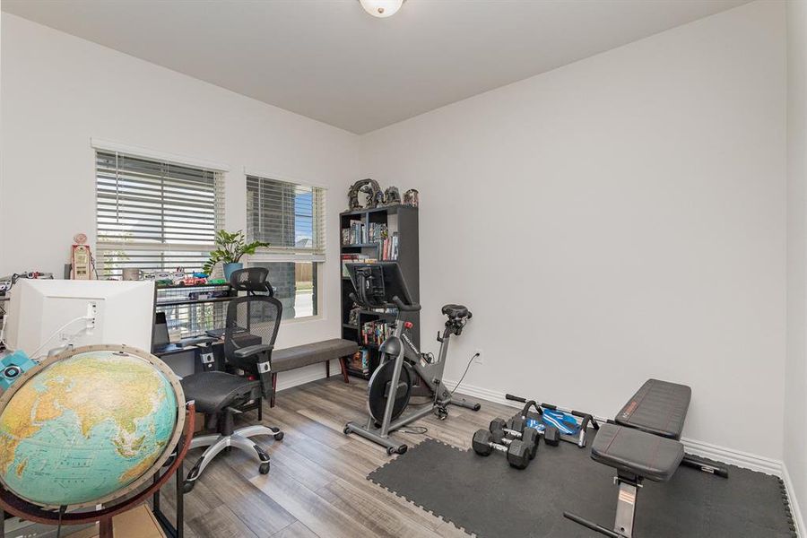 Exercise room featuring hardwood / wood-style flooring