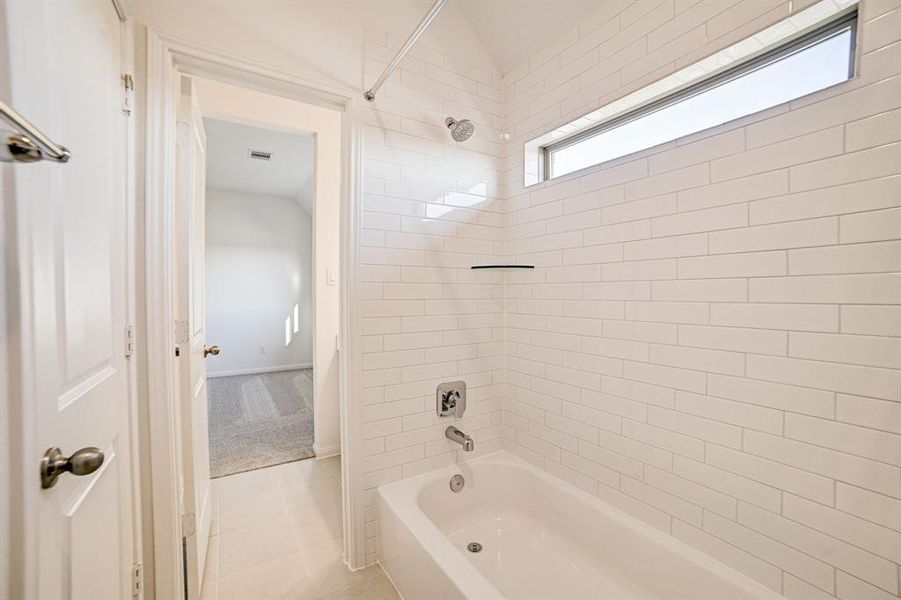 Full bathroom upstairs with beautiful upgraded white subway tile.