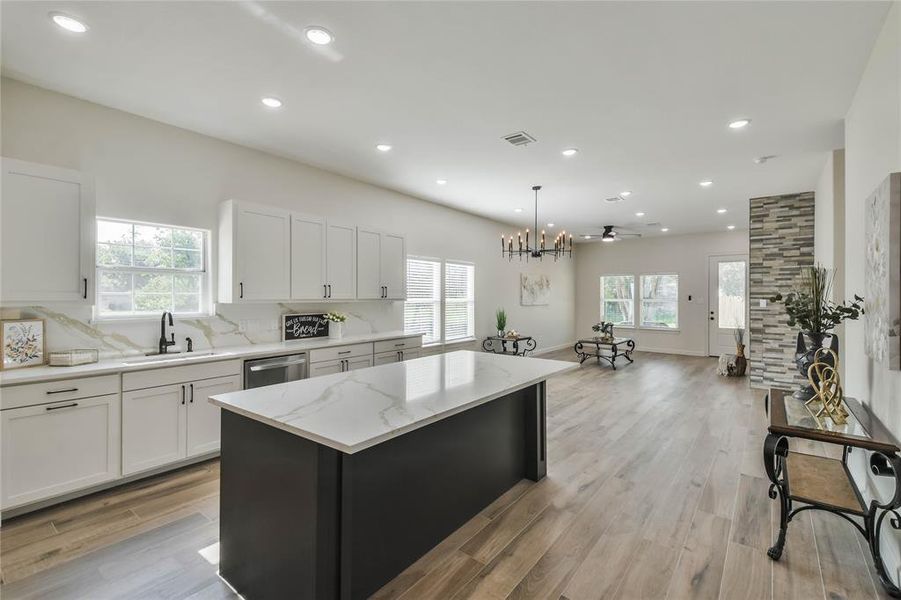 Open floor plan with magnificent kitchen and living space--all Gold Calacatta 1" Quartz counters and backsplash through out the home.