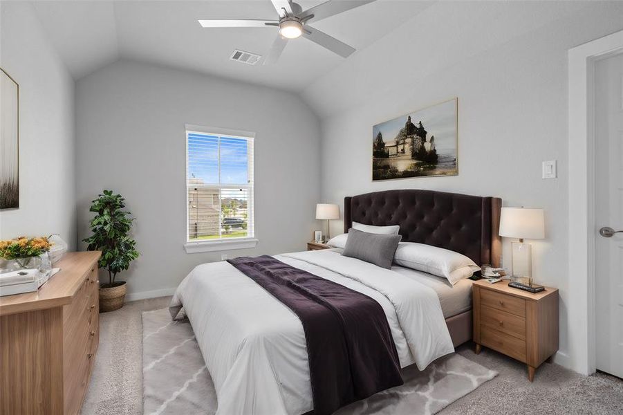 Secondary bedroom features plush carpet, custom paint, ceiling fan, and a large window with privacy blinds.
