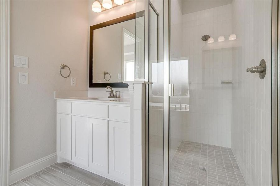 Bathroom featuring vanity and an enclosed shower