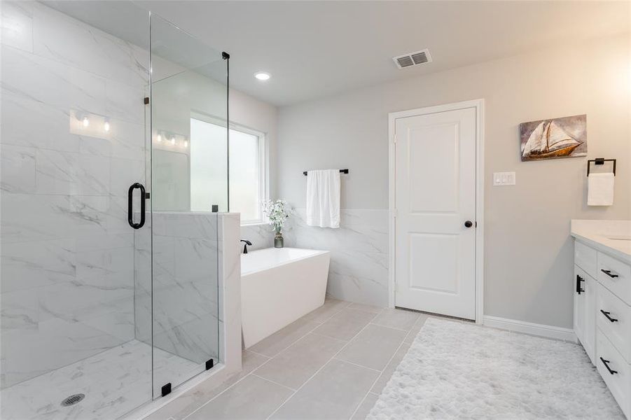 Bathroom featuring tile walls, vanity, separate shower and tub, and tile patterned flooring