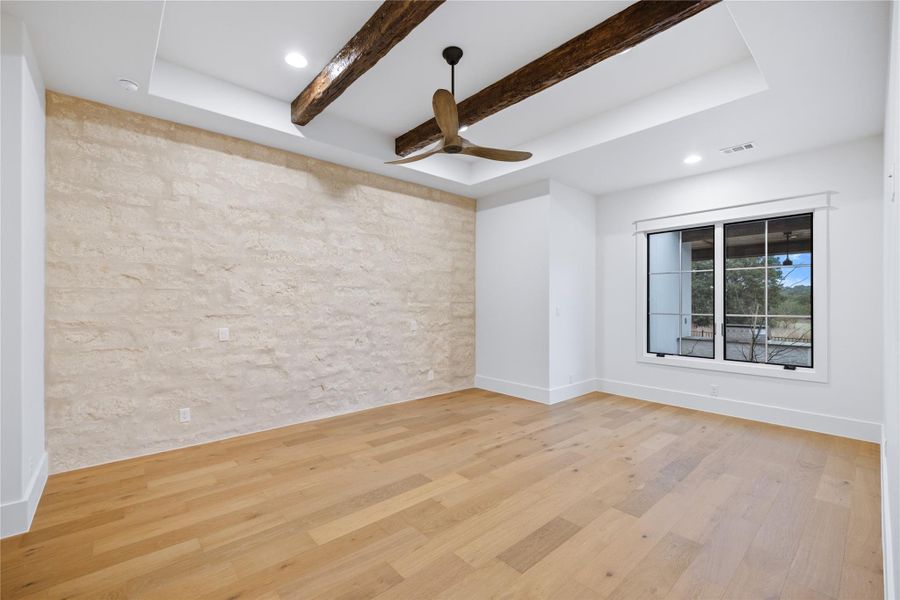 Stone wall in primary bedroom