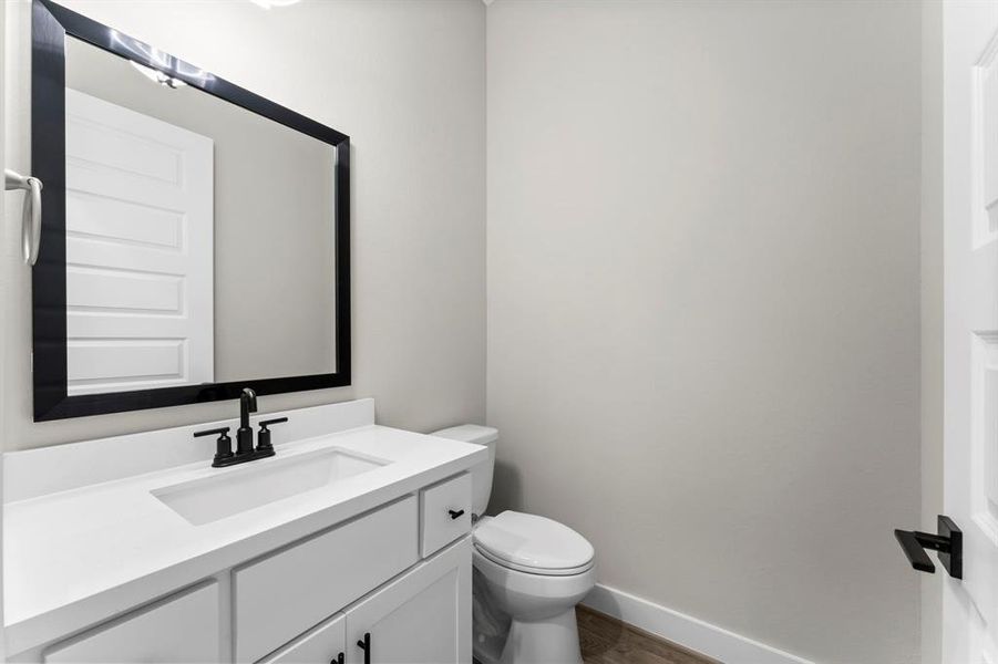 Downstairs powder bath next to the flex room and kitchen.