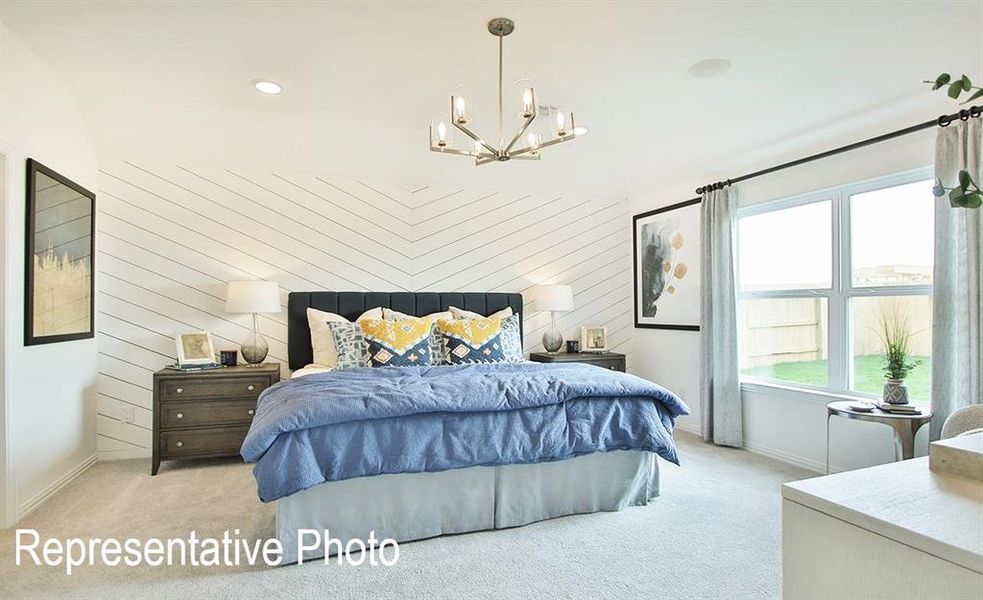 Carpeted bedroom featuring a notable chandelier