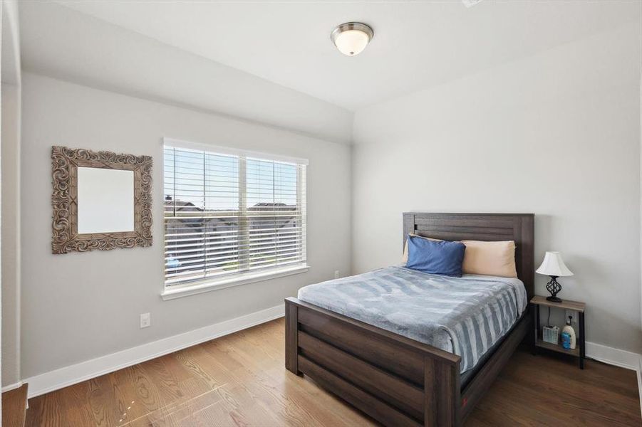 Bedroom with wood-type flooring