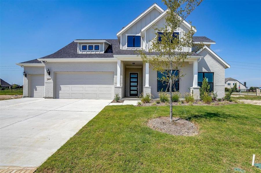 Craftsman house with a garage and a front lawn