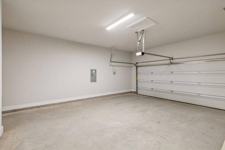 Garage with a garage door opener and electric panel