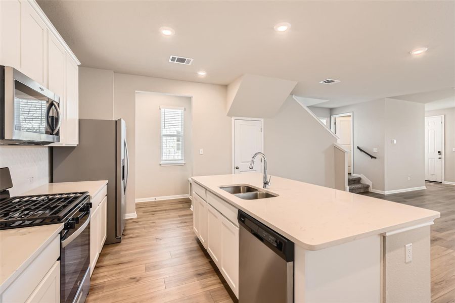 The kitchen island overlooks the main living area making it east to stay connected while making meals and cleaning up the dishes.