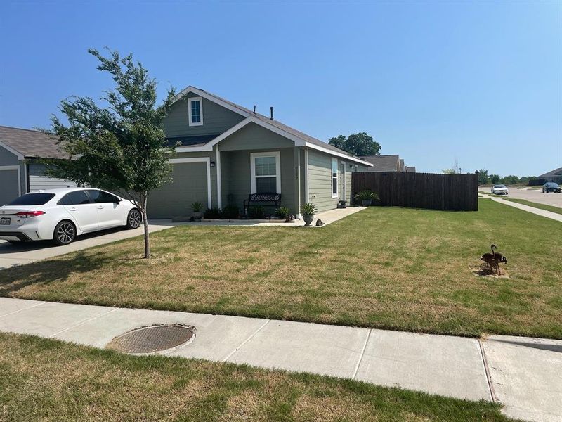 View of front of home featuring a front yard and a garage