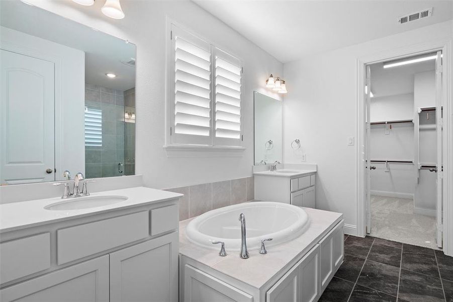 Bathroom with vanity, separate shower and tub, and tile patterned floors