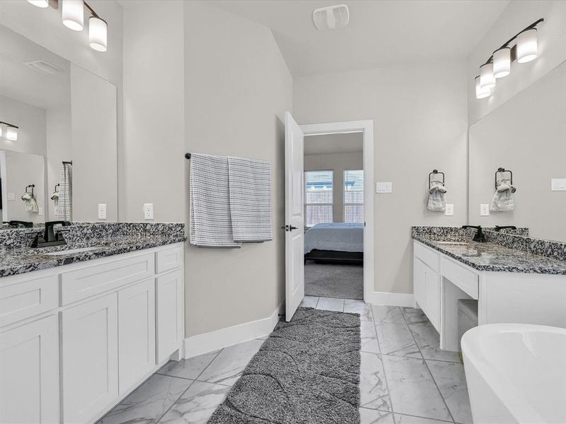 Bathroom featuring vanity and a bath