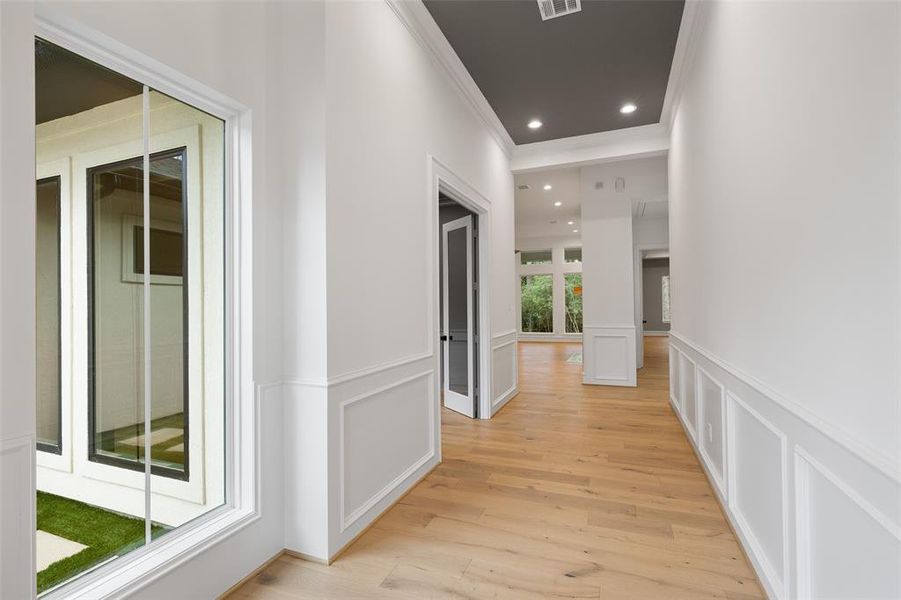 You are welcomed into the home with soaring ceilings and Shaw engineered hardwood flooring.