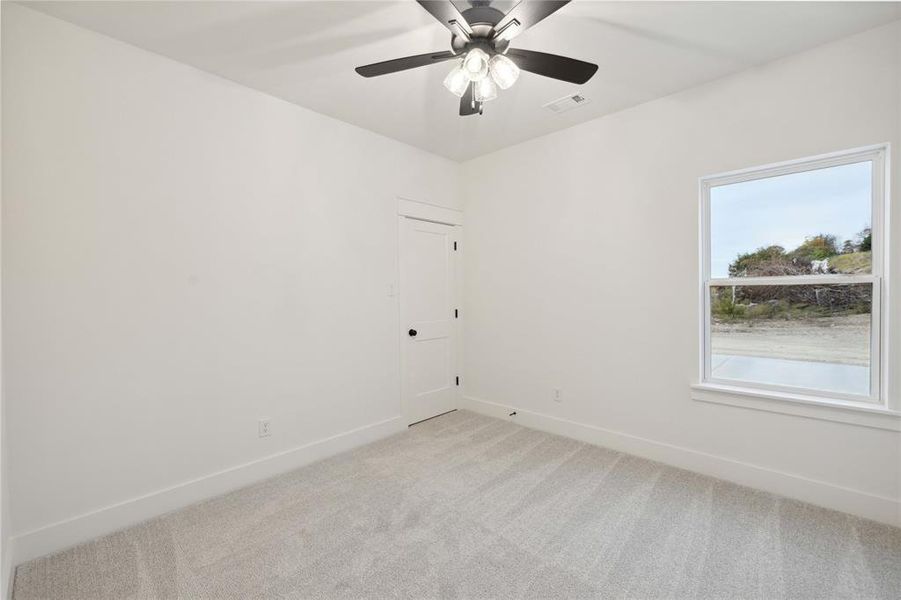 Unfurnished room featuring carpet flooring and ceiling fan