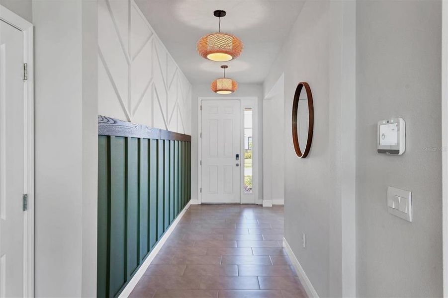 Hallway has a beautiful feature wall and lighting fixtures!