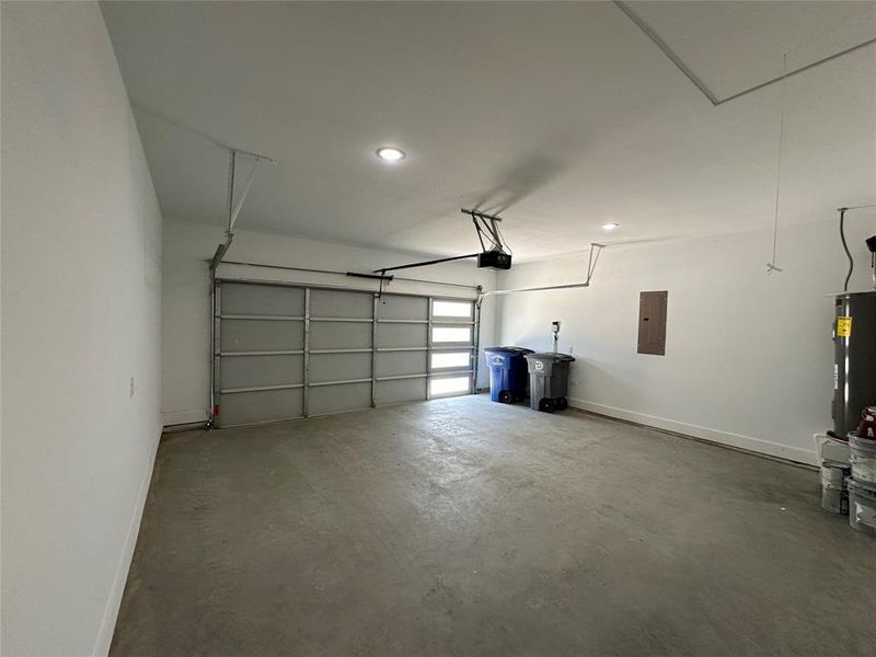 Garage featuring a garage door opener and water heater 4 lite garage door for lighting up the garage during the day - natural light.
