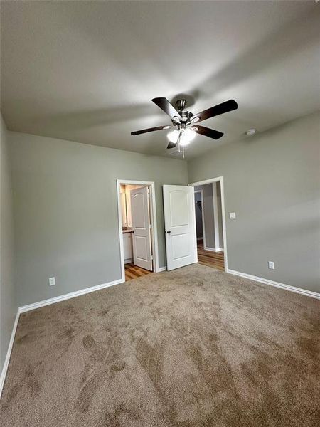 Unfurnished room featuring carpet and ceiling fan