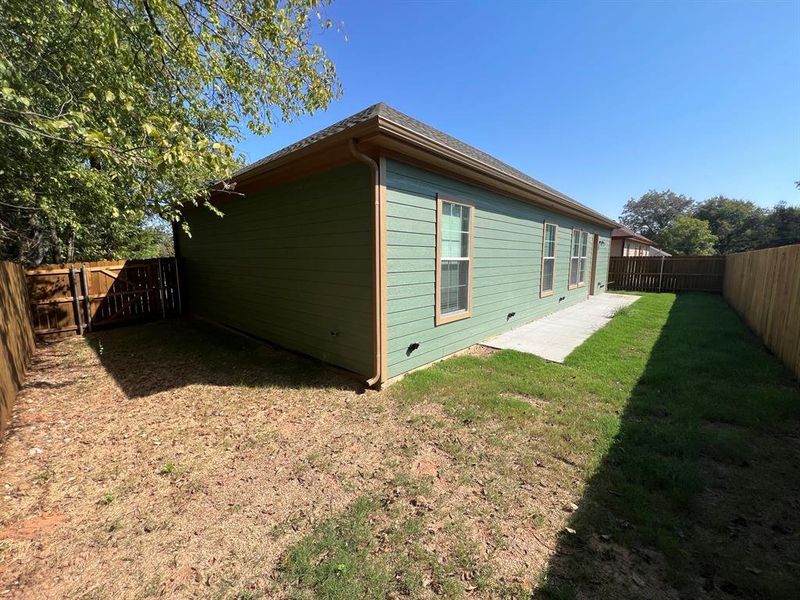 View of side of home with a yard