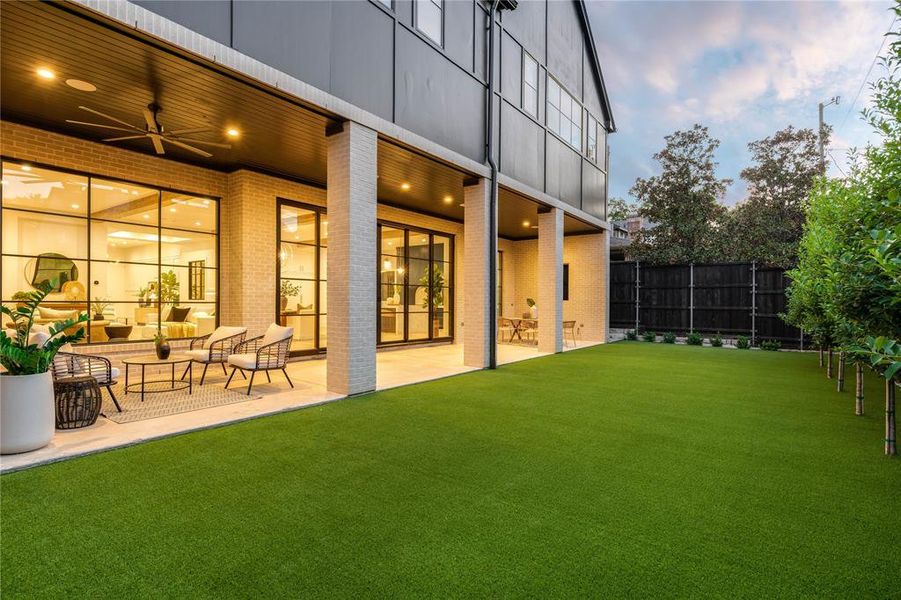 View of yard with ceiling fan, outdoor lounge area, and a patio area