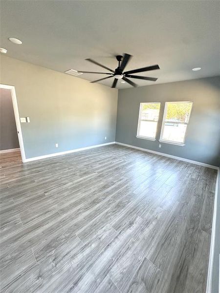 Unfurnished room with light wood-type flooring and ceiling fan