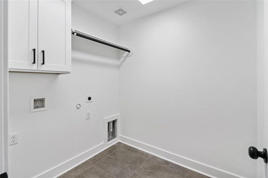 Spacious In-House utility room with enclosed cabinet, soap shelf, and hanging rack