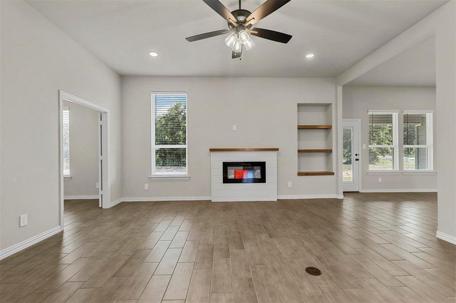 Unfurnished living room with hardwood / wood-style floors and ceiling fan