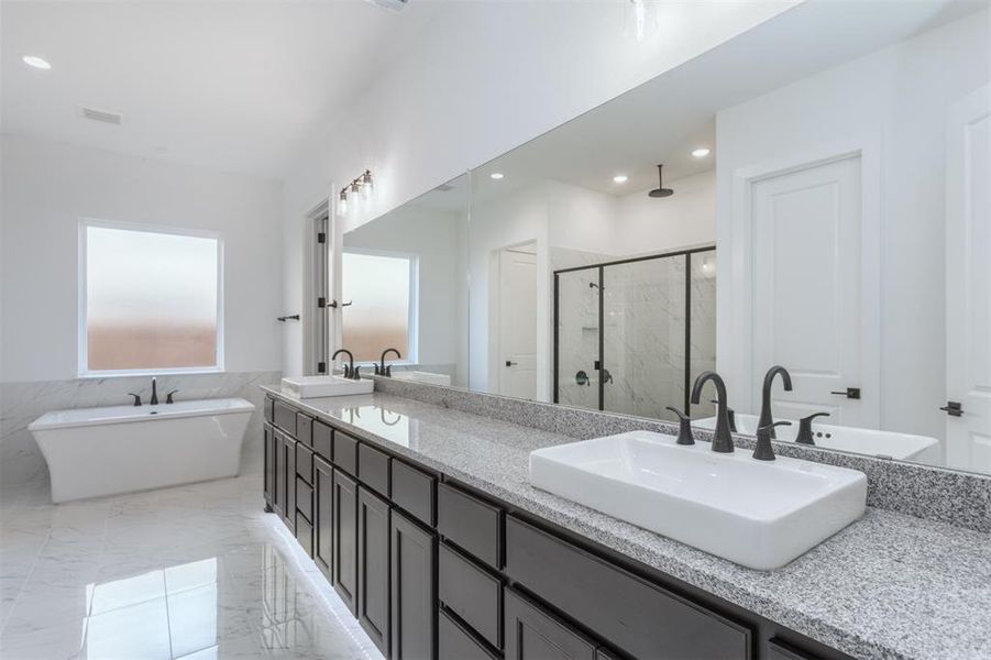 Bathroom featuring vanity and plus walk in shower