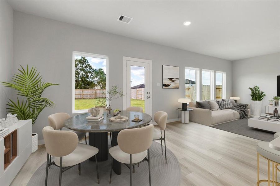 Start your day off right with a cup of coffee sitting with your family in the lovely dining area! Featuring large windows, custom neutral paint, EVP flooring, recessed lighting and high ceilings.